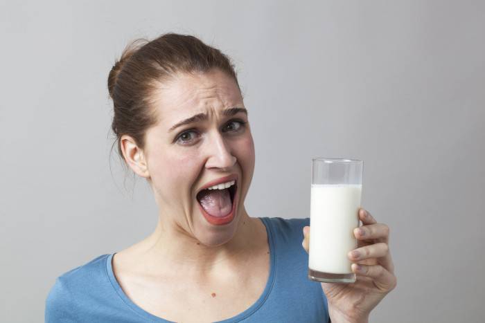 shouting girl disgusted at dieting white protein liquids
