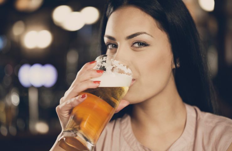 Una donna che beve birra