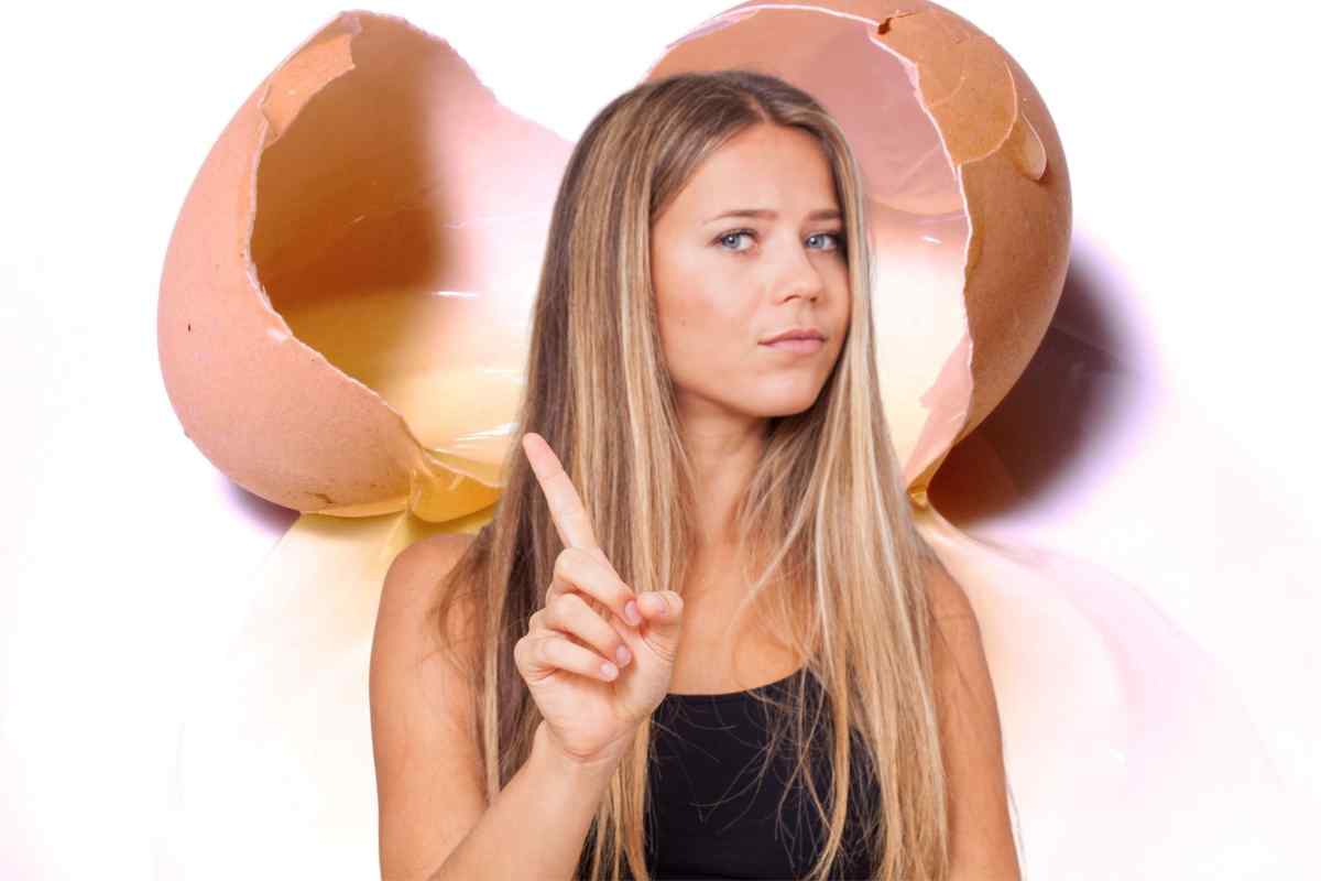 donna fa di no col dito davanti a un uovo rotto